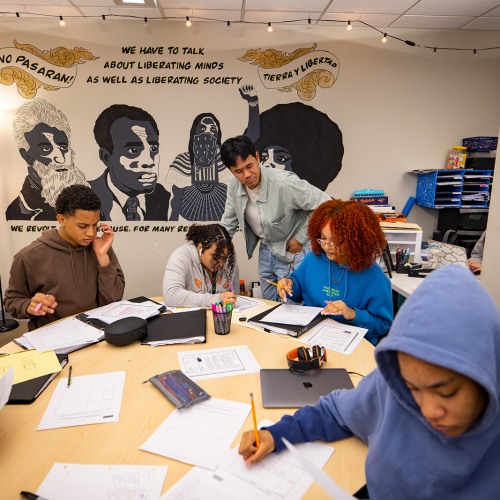 a teacher aide monitoring  a high school classroom