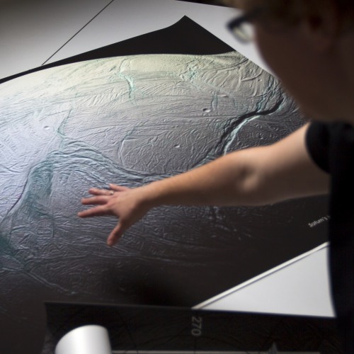 Student Gesturing to Picture of Planet