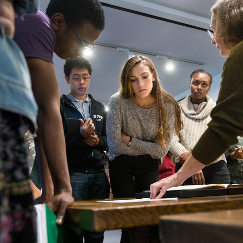 Students studying texts on a desk