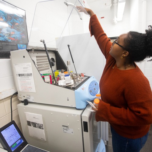 Student using machine in lab