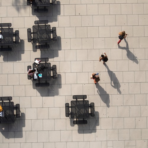 Aerial view of students walking on tiled pathway