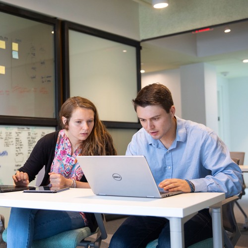Students working at a laptop