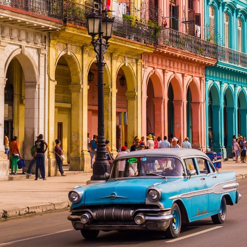South American town with colorful buildings and vintage car