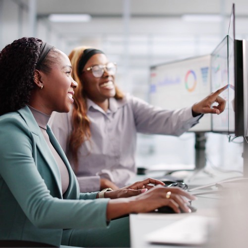 Students sitting at a desk looking at a monitor.