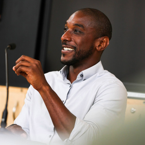 david blanding teaching while seated in the front of a classroom